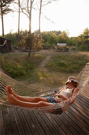 shorts female hammock - Sweden, Bohuslan, Woman taking nap in hammock Stock Photo - Premium Royalty-Free, Code: 6126-08642936