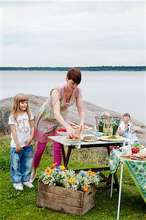 picnic 40 - Sweden, Uppland, Roslagen, Woman preparing picnic table at seaside Stock Photo - Premium Royalty-Free, Code: 6126-08643038