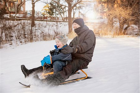 simsearch:6126-08635937,k - Sweden, Sodermanland, Johanneshov, Father with son (4-5) tobogganing Stock Photo - Premium Royalty-Free, Code: 6126-08643191