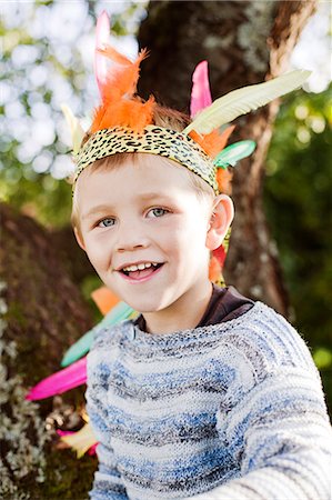 simsearch:6126-08644046,k - Sweden, Sodermanland, Strangnas, Portrait of smiling boy (4-5) wearing plume Stock Photo - Premium Royalty-Free, Code: 6126-08643112