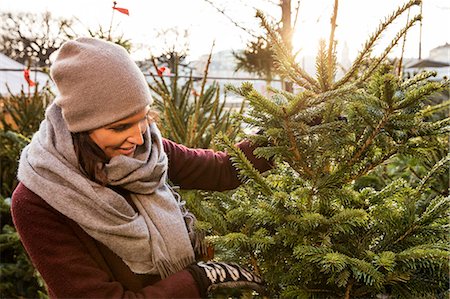 shopping christmas not holiday not fruit - Sweden, Stockholm, Gamla Stan, Woman choosing christmas tree Stock Photo - Premium Royalty-Free, Code: 6126-08643212