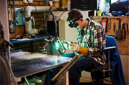 simsearch:6126-08644046,k - Sweden, Young man welding metal Stock Photo - Premium Royalty-Free, Code: 6126-08643223
