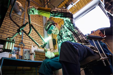 simsearch:6126-08636707,k - Sweden, Young man welding metal Stock Photo - Premium Royalty-Free, Code: 6126-08643224