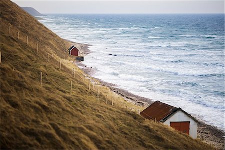 scandinavian blue house - Sweden, Skane, Malmo, Houses along coastline by sea Stock Photo - Premium Royalty-Free, Code: 6126-08643597