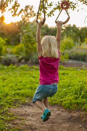 Sweden, Skane, Osterlen, Girl (4-5) swinging Stock Photo - Premium Royalty-Free, Code: 6126-08643796