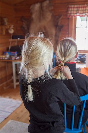 Norway, Girl (10-11) tying mother's hair Stock Photo - Premium Royalty-Free, Code: 6126-08643860