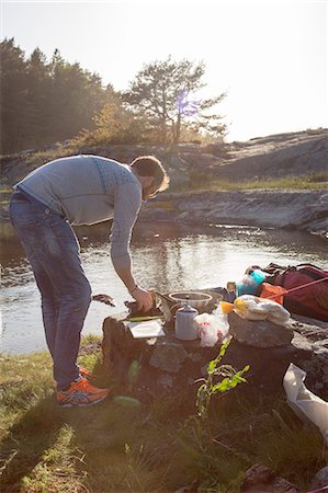 simsearch:6126-08643872,k - Sweden, West Coast, Bohuslan, Flato, Man camping on riverbank Photographie de stock - Premium Libres de Droits, Code: 6126-08643874