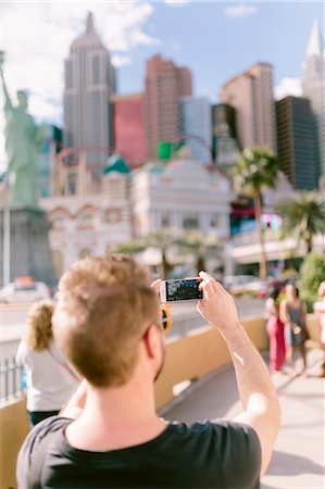 USA, Nevada, Las Vegas, Man taking picture with smart phone Stock Photo - Premium Royalty-Free, Code: 6126-08643947