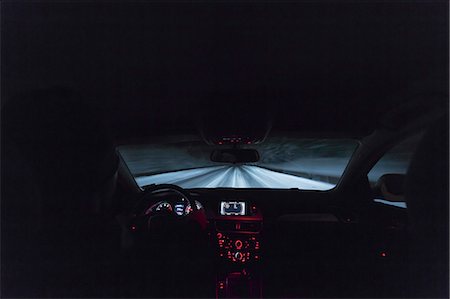 Sweden, Vasterbotten, Umea, Over shoulder view of man driving at night Stock Photo - Premium Royalty-Free, Code: 6126-08643956