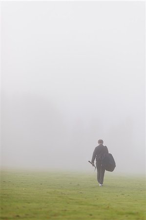 Sweden, Vastmanland, Teenage boy (14-15) walking in green field in fog Stock Photo - Premium Royalty-Free, Code: 6126-08643991