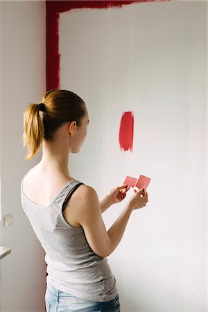 simsearch:6126-08659298,k - Sweden, Woman comparing color swatches against wall Stock Photo - Premium Royalty-Free, Code: 6126-08644061