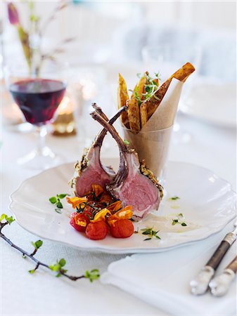 still life meat tomato - Sweden, Lamb chops and french fries on table Photographie de stock - Premium Libres de Droits, Code: 6126-08644194