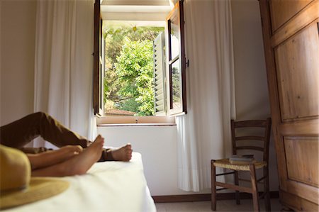 Italy, Couple lying on bed in farmhouse Stock Photo - Premium Royalty-Free, Code: 6126-08644358