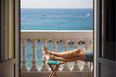 Italy, Cinque Terra, Monterosso, Man resting on balcony with sea view Photographie de stock - Premium Libres de Droits, Code: 6126-08644365
