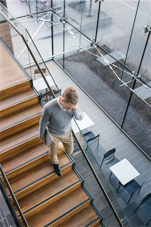 simsearch:6126-08644046,k - Finland, Young businessman walking downstairs and talking on phone Stock Photo - Premium Royalty-Free, Code: 6126-08644906