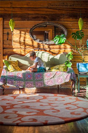 finnish ethnicity (male) - Finland, Boy (8-9) sitting on sofa and reading book Stock Photo - Premium Royalty-Free, Code: 6126-08644919