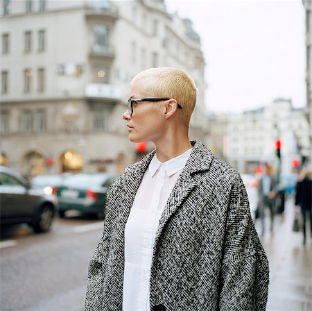 swedish ethnicity (female) - Sweden, Stockholm, Mid adult woman standing on city street looking away Stock Photo - Premium Royalty-Free, Code: 6126-08658886