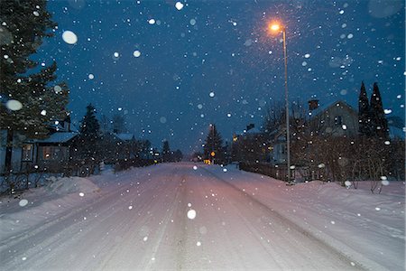 street light at night - Sweden, Sodermanland, Stigtomta, Illuminated village street in winter Stock Photo - Premium Royalty-Free, Code: 6126-08659074