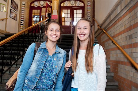 school friends standing - Portrait of two girls (14-15) in school building Stock Photo - Premium Royalty-Free, Code: 6126-08659017