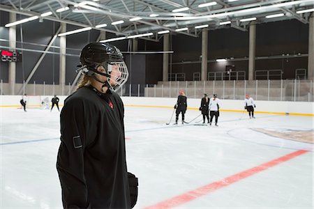 simsearch:6126-08659298,k - Sweden, Young hockey player wearing helmet standing on rink Stock Photo - Premium Royalty-Free, Code: 6126-08659038