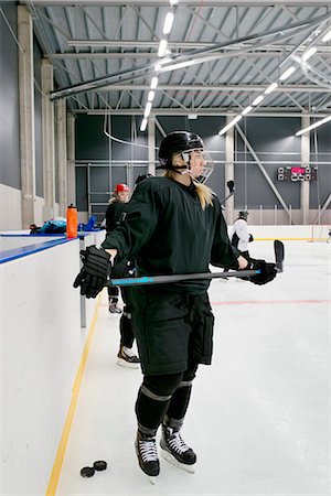 Sweden, Young ice hockey players by ice rink boarding Stock Photo - Premium Royalty-Free, Code: 6126-08659039