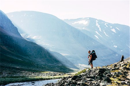simsearch:6126-08644654,k - Sweden, Lapland, Ladtjovagge, Kungsleden, Male hiker standing by river in mountain valley Stock Photo - Premium Royalty-Free, Code: 6126-08635054