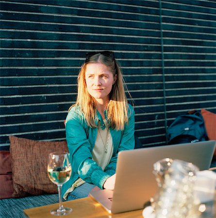 pictures of people seating on a table - Sweden, Sodermanland, Nacka, Sickla, Mid-adult woman surfing net at cafe Stock Photo - Premium Royalty-Free, Code: 6126-08635145