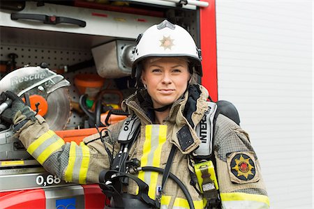 Sweden, Portrait of female firefighter by fire engine Stockbilder - Premium RF Lizenzfrei, Bildnummer: 6126-08635155