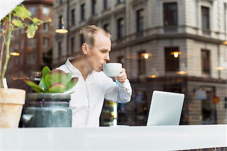 simsearch:6126-08642990,k - Sweden, Uppland, Stockholm, Man drinking tea Stock Photo - Premium Royalty-Free, Code: 6126-08635165