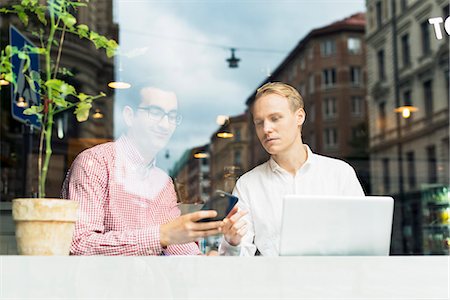 simsearch:6126-08642990,k - Sweden, Uppland, Stockholm, Two men talking in cafe Stock Photo - Premium Royalty-Free, Code: 6126-08635166