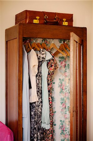 simsearch:614-08989897,k - Italy, Liguria, Imperia, Diano Marina, Clothes hanging in open wooden wardrobe Photographie de stock - Premium Libres de Droits, Code: 6126-08635279