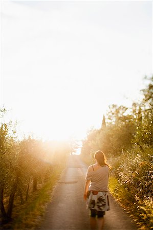 simsearch:6126-08644371,k - Italy, Tuscany, Rear view of woman walking on road Photographie de stock - Premium Libres de Droits, Code: 6126-08635217