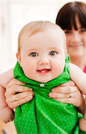 Sweden, mother showing off her baby girl (18-23 months) Stock Photo - Premium Royalty-Free, Code: 6126-08635325