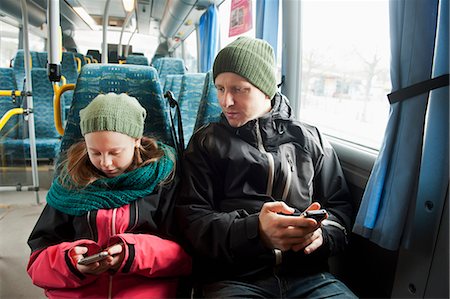 simsearch:614-06442908,k - Sweden, Stockholm, Girl (10-11) with father sitting in tram and using smart phones Stock Photo - Premium Royalty-Free, Code: 6126-08635499