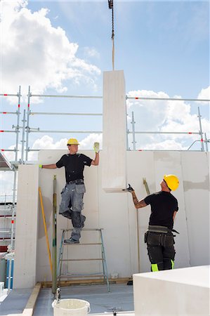 simsearch:6126-09104272,k - Sweden, Ostergotland, Linkoping, Construction workers lifting up blocks on construction site Stock Photo - Premium Royalty-Free, Code: 6126-08635551
