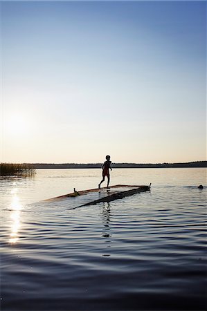 seven years old girls - Sweden, Vastra Gotaland, Skagern, Children (6-7, 10-11) swimming in lake Stock Photo - Premium Royalty-Free, Code: 6126-08635985