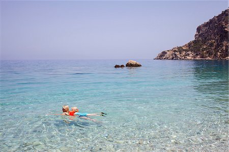 Greece, Karpathos, Amopi, Woman and girl (6-7) swimming in sea Stock Photo - Premium Royalty-Free, Code: 6126-08635997
