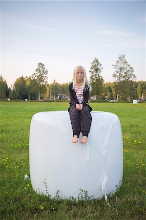 Sweden, Narke, Kilsbergen, Girl (10-11) sitting on hay bale Stock Photo - Premium Royalty-Free, Code: 6126-08636044
