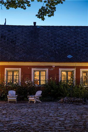 scandinavian - Sweden, Skane, Osterlen, Skillinge, Borrby, Kvarnby, Illuminated backyard of hostel Ostangard at dusk Stock Photo - Premium Royalty-Free, Code: 6126-08636082