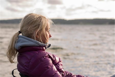 Sweden, Bohuslan, Halleback, Portrait of blonde mature woman sitting at seaside Stock Photo - Premium Royalty-Free, Code: 6126-08636016