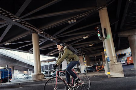 simsearch:6126-08636176,k - Sweden, Sodermanland, Stockholm, Sodermalm, Slussen, Mid adult man cycling in city Stock Photo - Premium Royalty-Free, Code: 6126-08636141