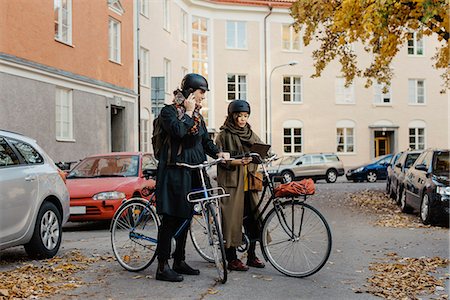 Sweden, Uppland, Stockholm, Vasastan, Rodabergsbrinken, Two people standing with bicycles outdoors Stock Photo - Premium Royalty-Free, Code: 6126-08636168