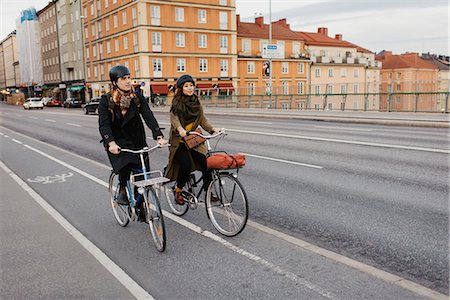 Sweden, Uppland, Stockholm, Vasatan, Sankt Eriksgatan, Man and woman cycling on city street Stock Photo - Premium Royalty-Free, Code: 6126-08636172
