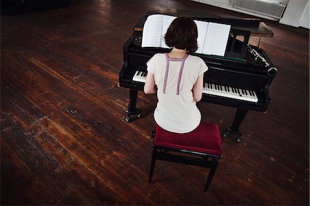 simsearch:6126-09102672,k - Sweden, Rear view of woman playing piano Stock Photo - Premium Royalty-Free, Code: 6126-08636127