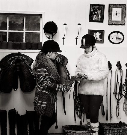 Sweden, Teenage girl (14-15) and woman preparing saddle Photographie de stock - Premium Libres de Droits, Code: 6126-08636249