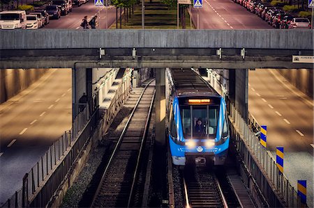 simsearch:6126-08636348,k - Sweden, Stockholm, Elevated view of train in city at dusk Stock Photo - Premium Royalty-Free, Code: 6126-08636347
