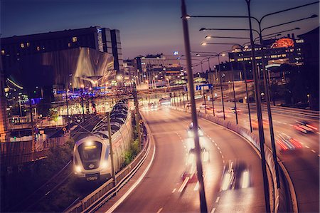 simsearch:6126-08636348,k - Sweden, Stockholm, Elevated view of city with highway and train at dusk Stock Photo - Premium Royalty-Free, Code: 6126-08636346