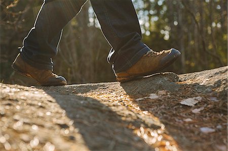 foot (human) - Finland, Esbo, Kvarntrask, Low section shot of young man walking in forest Stock Photo - Premium Royalty-Free, Code: 6126-08636698