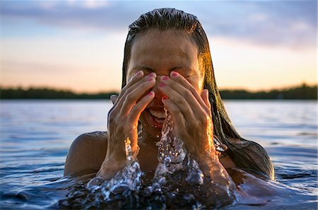 simsearch:6126-08636707,k - Finland, Pohjanmaa, Luoto, Young woman coming out of water Stock Photo - Premium Royalty-Free, Code: 6126-08636766