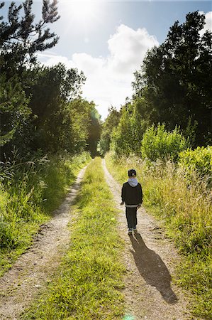 Back View of Father and Son on Dirt Road with Fishing Gear - Stock